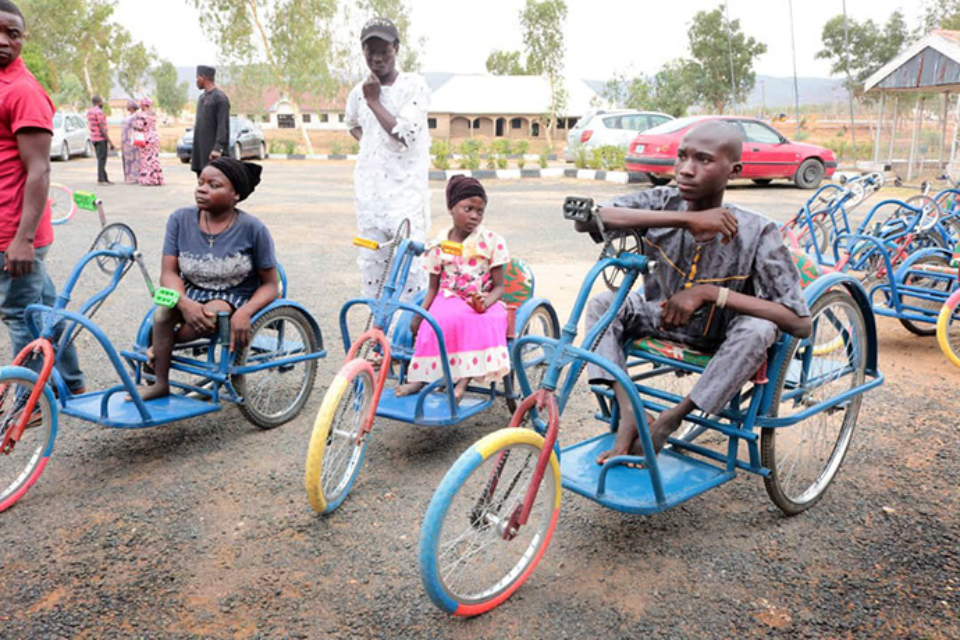 Nigerians receiving tricycles donated through United Methodist partnership.