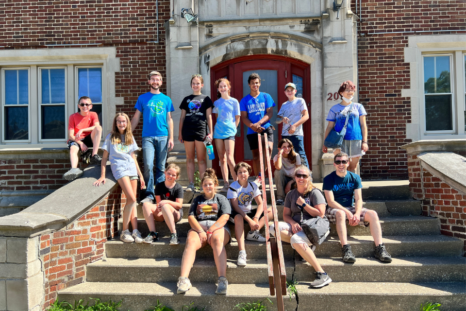 Youth standing in front of a building.