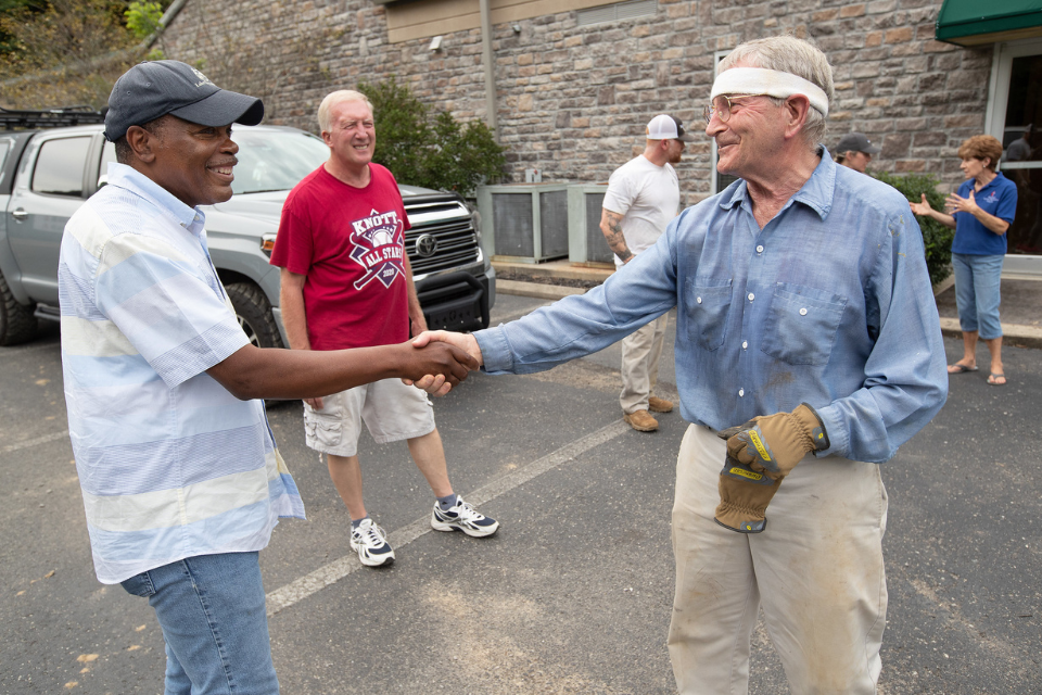 Bishop Fairley greets man in Kentucky after floods.