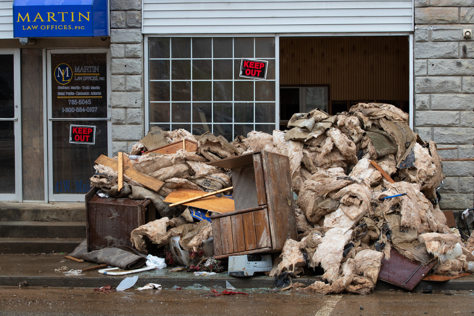 Offices and businesses piled up flood-damaged belongings on the street.