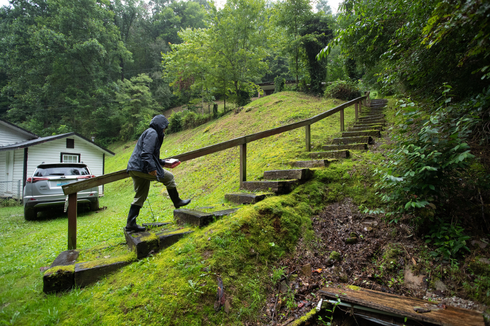 Woman walking up stairs to home in Kentucky.