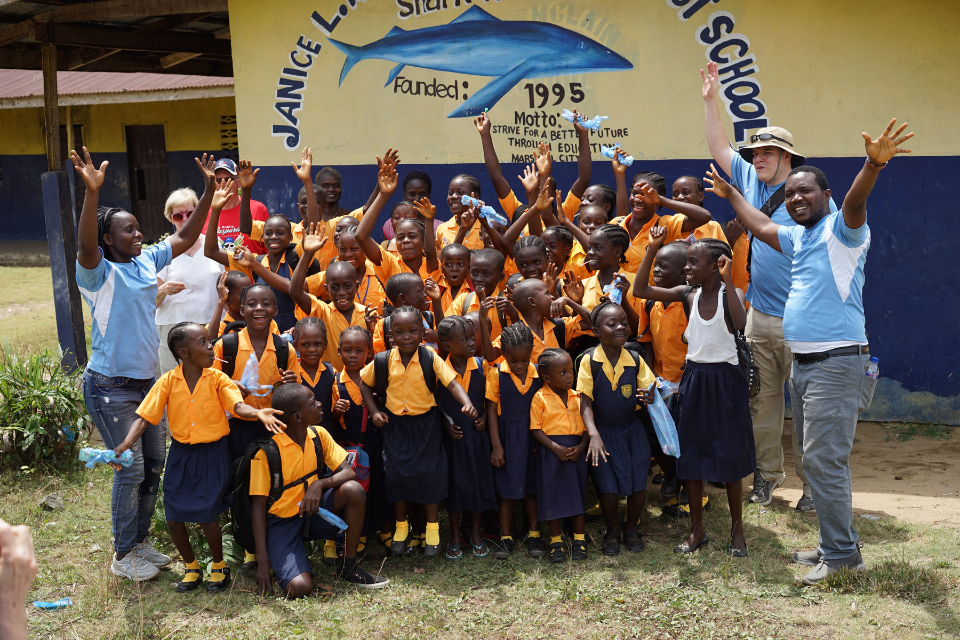 Students and volunteers in front of a school in Liberia