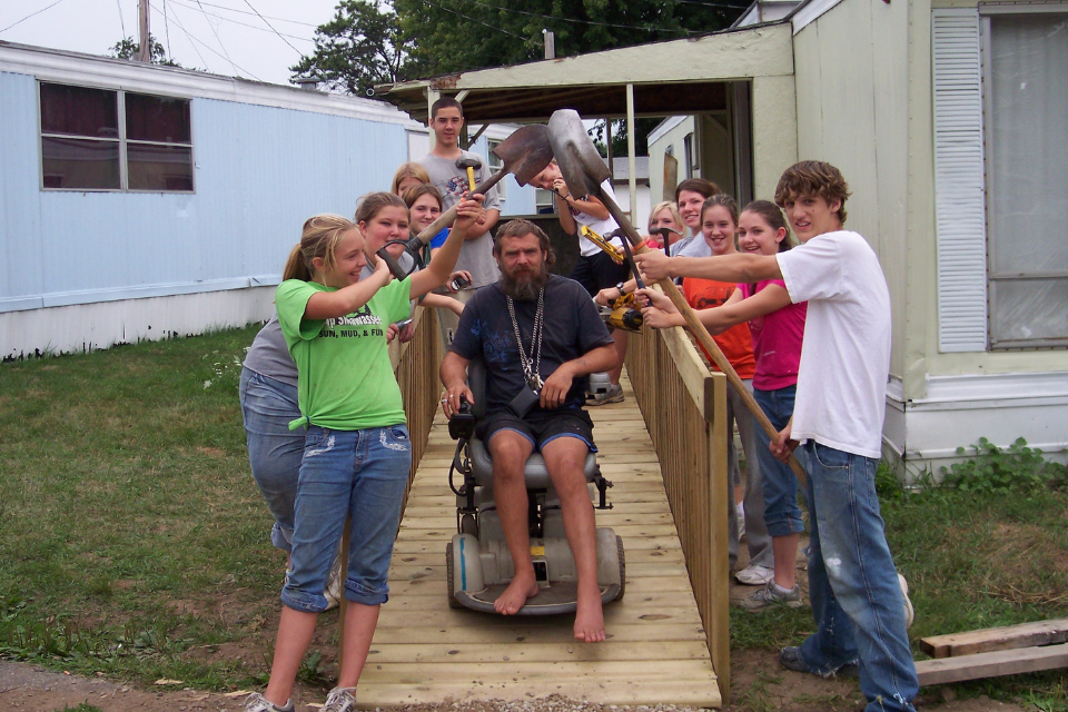 Teens helping build a ramp for a neighbor.