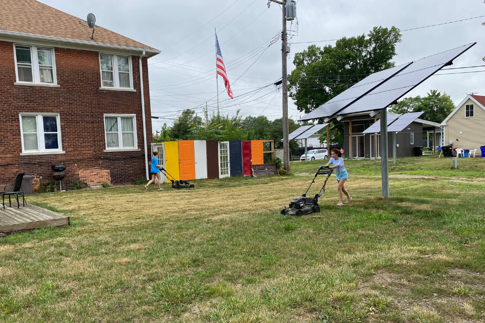 Youth mowing lawns.