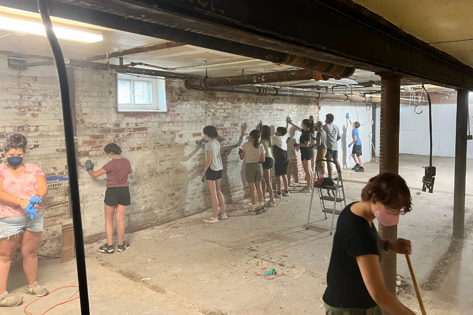 Youth painting a basement during a mission trip.