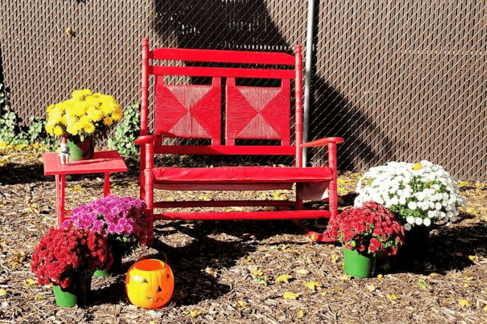 Red rocking chair with fall decor