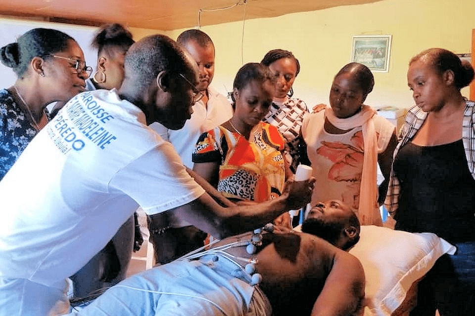 Staff being trained how to operate EKG equipment