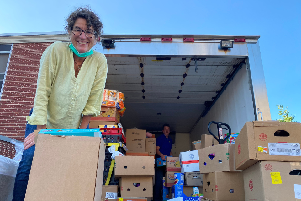 Pastor Jane Lippert receiving food from truck