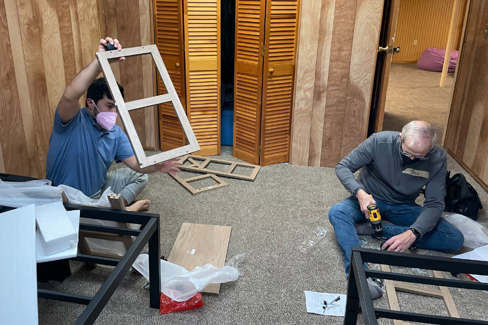 Two men building furniture