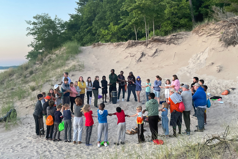 Campers hold hands during a prayer circle