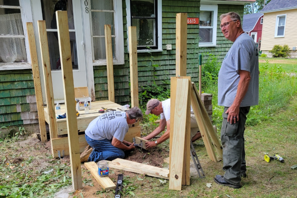 Volunteers helping to build a porch