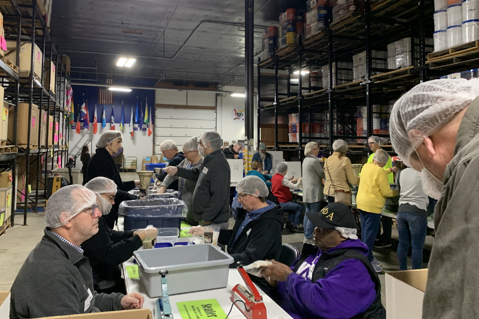 Volunteers packing rice meal bags