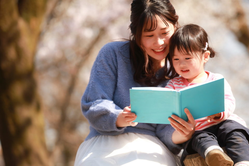 Woman reading a book to a small child
