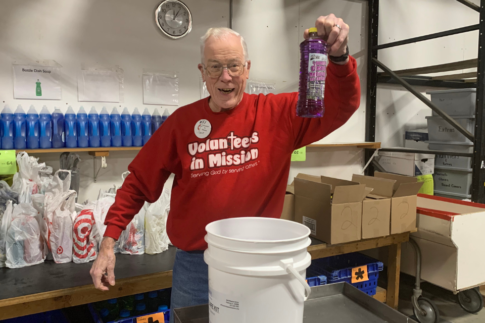 Volunteer packing a Home Care Kit