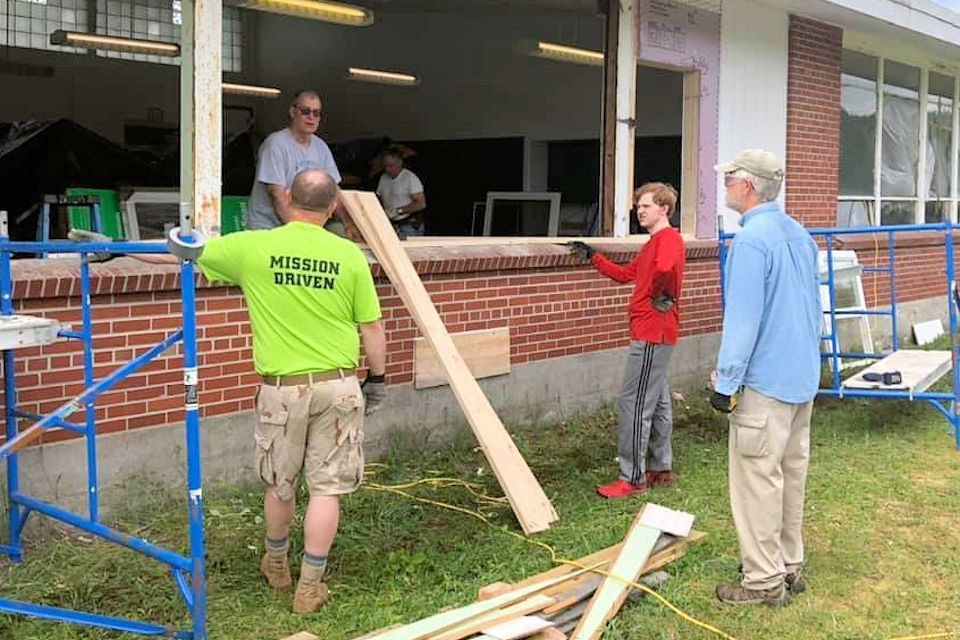 Volunteers repairing a building