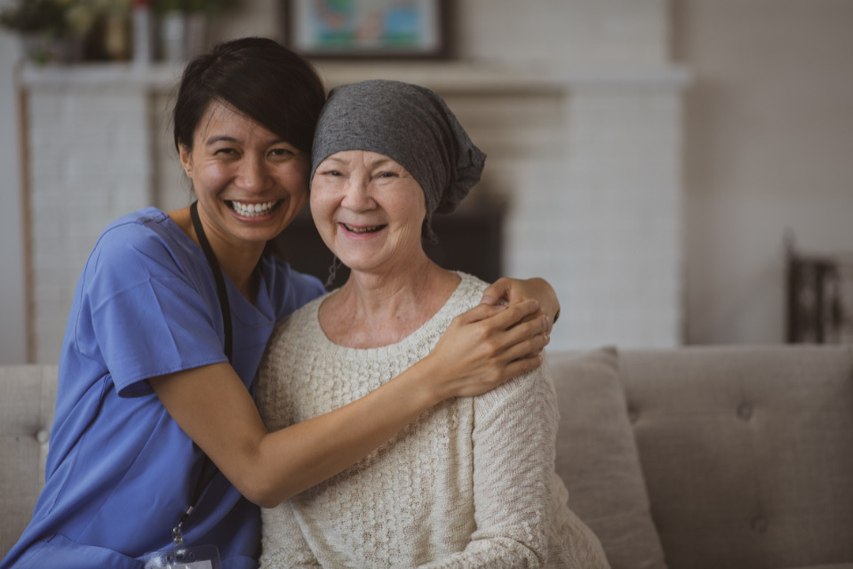 Nurse hugging cancer patient