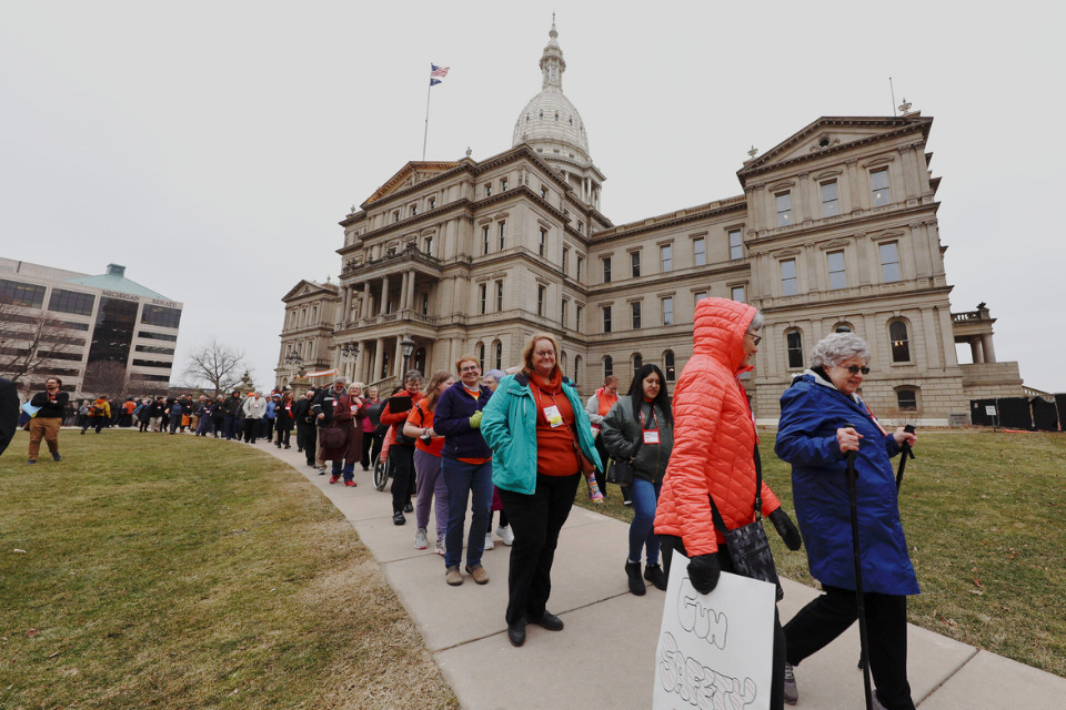 People walking from the Michigan State Capitol