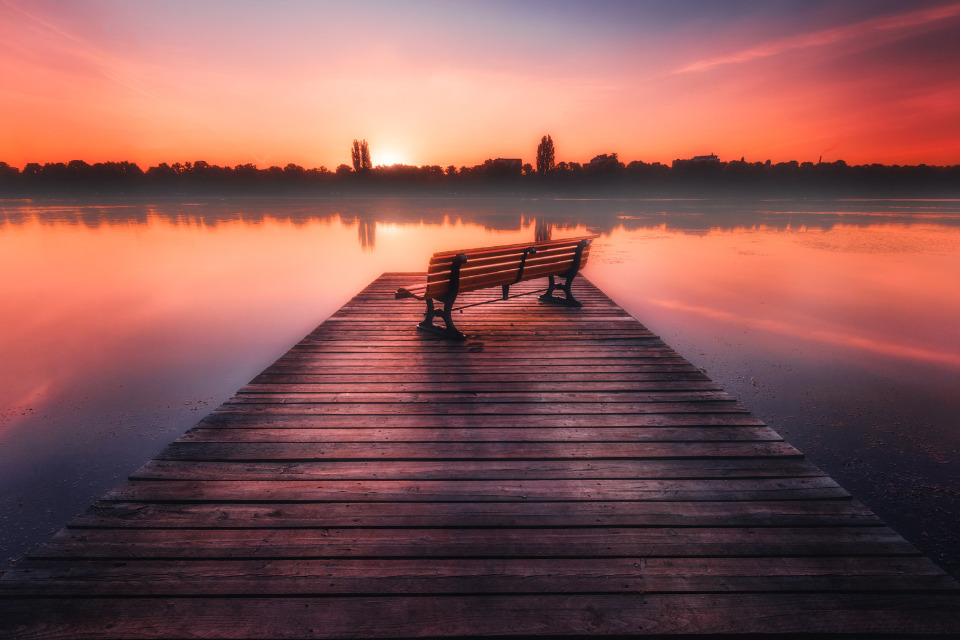 Empty bench on lake
