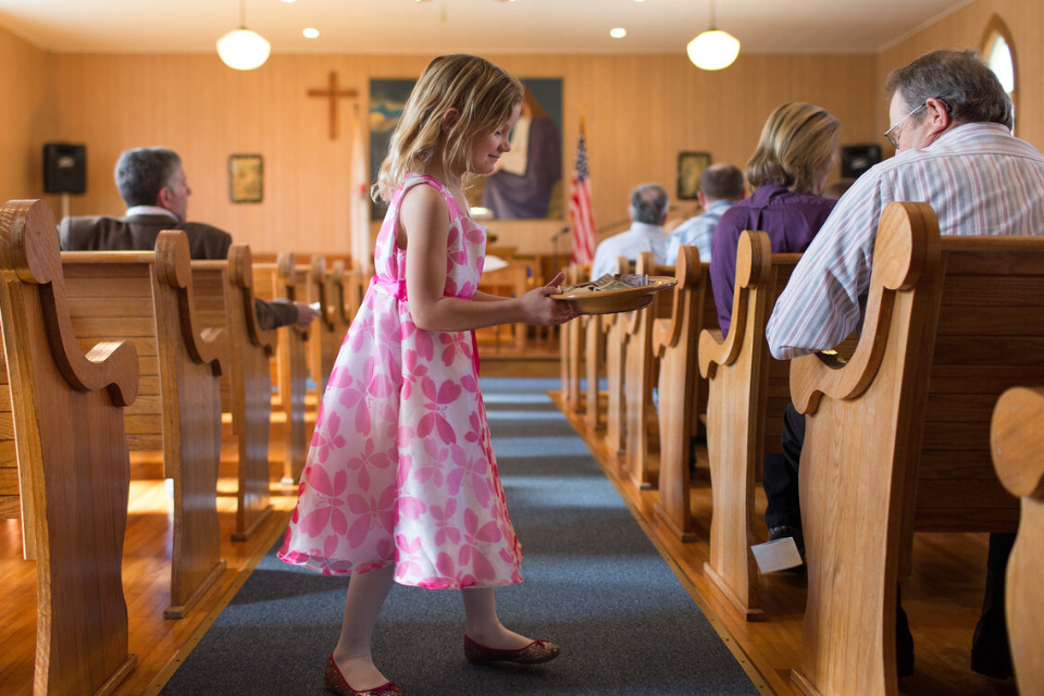 Girl taking up offering at church