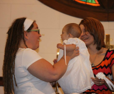 Suzy baptizing a child