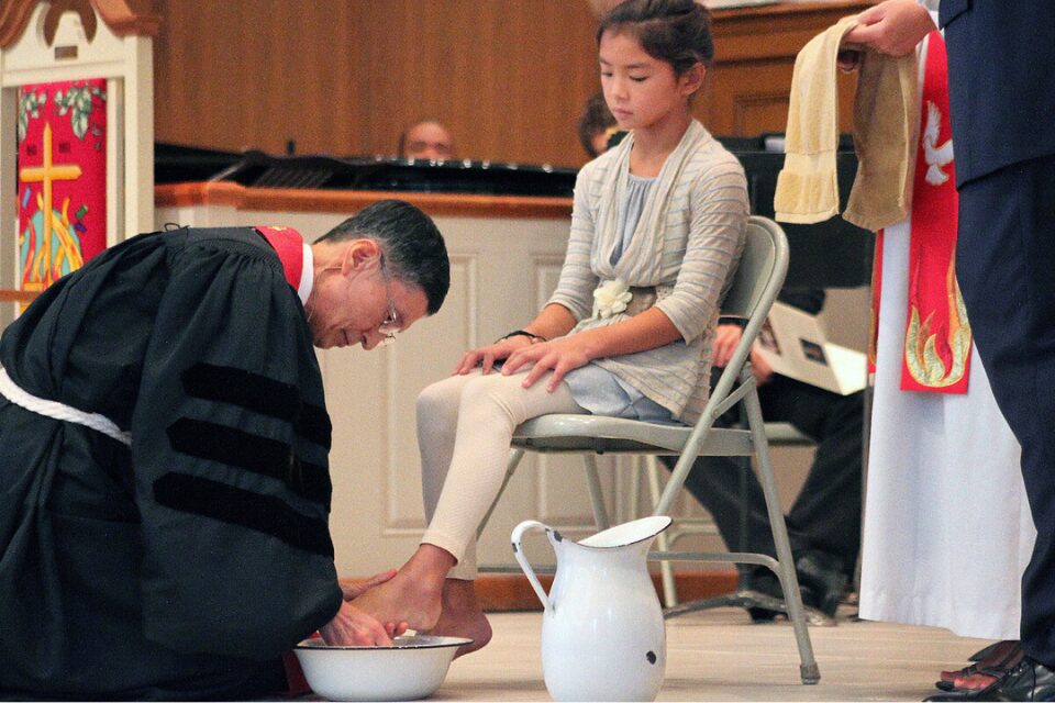 Bishop washing the feet of a young person