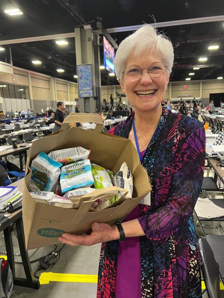 Woman holding bag of snacks