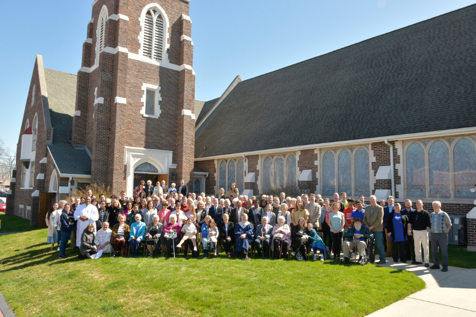 Congregation standing in front of church for photo shoot