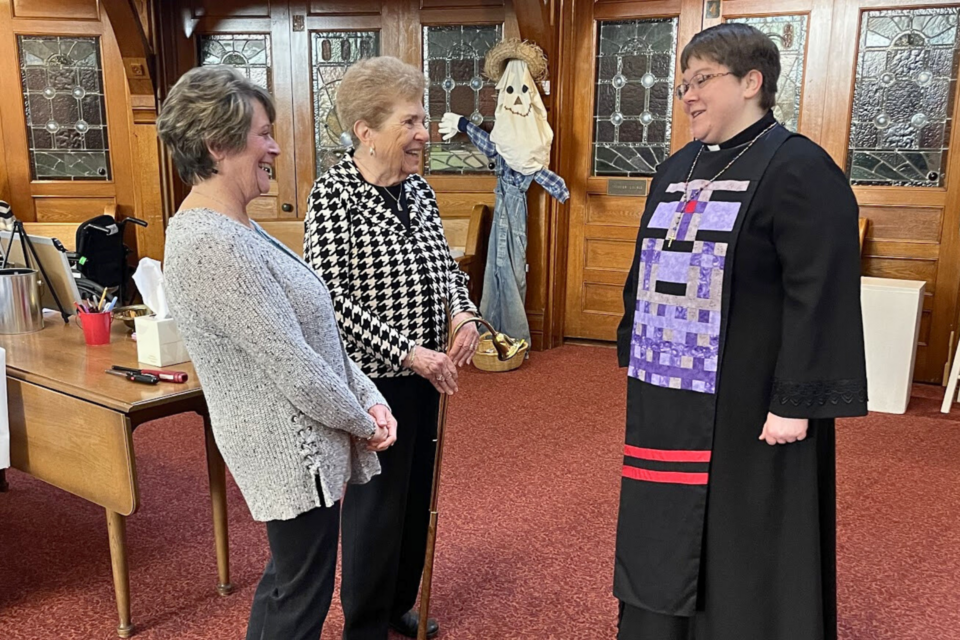 Pastor greeting guests at church