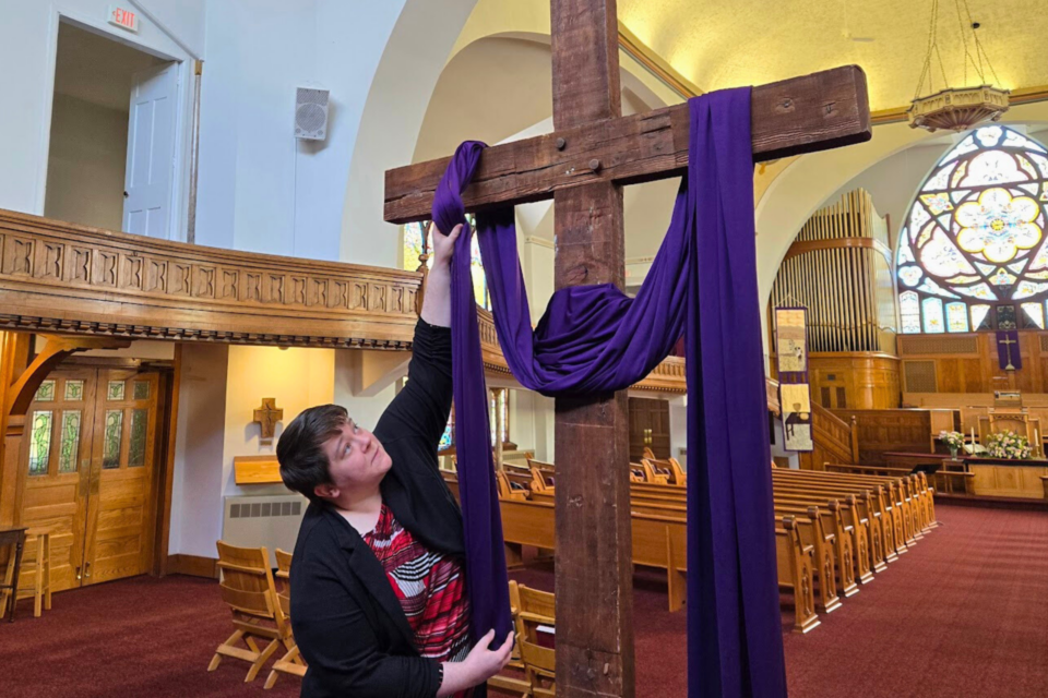 Woman decorating cross