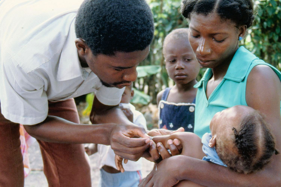Doctor helping a child and mother