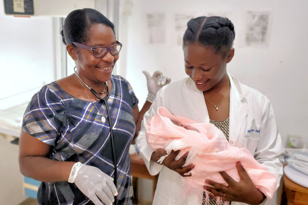 Doctor and nurse holding baby