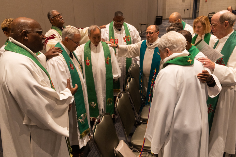 Bishops praying together