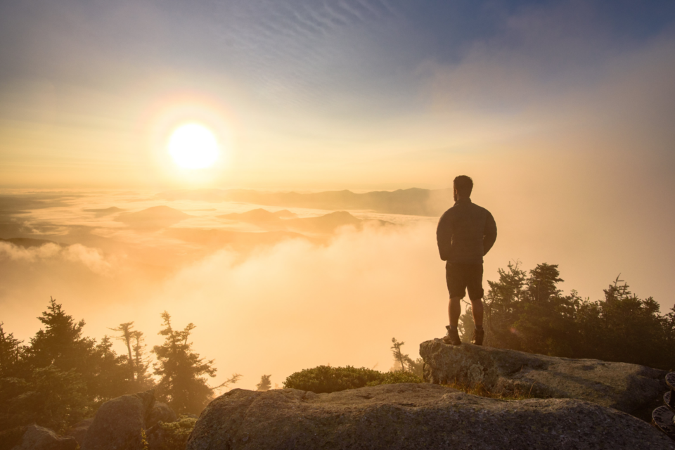 Man looking at sun at sunrise