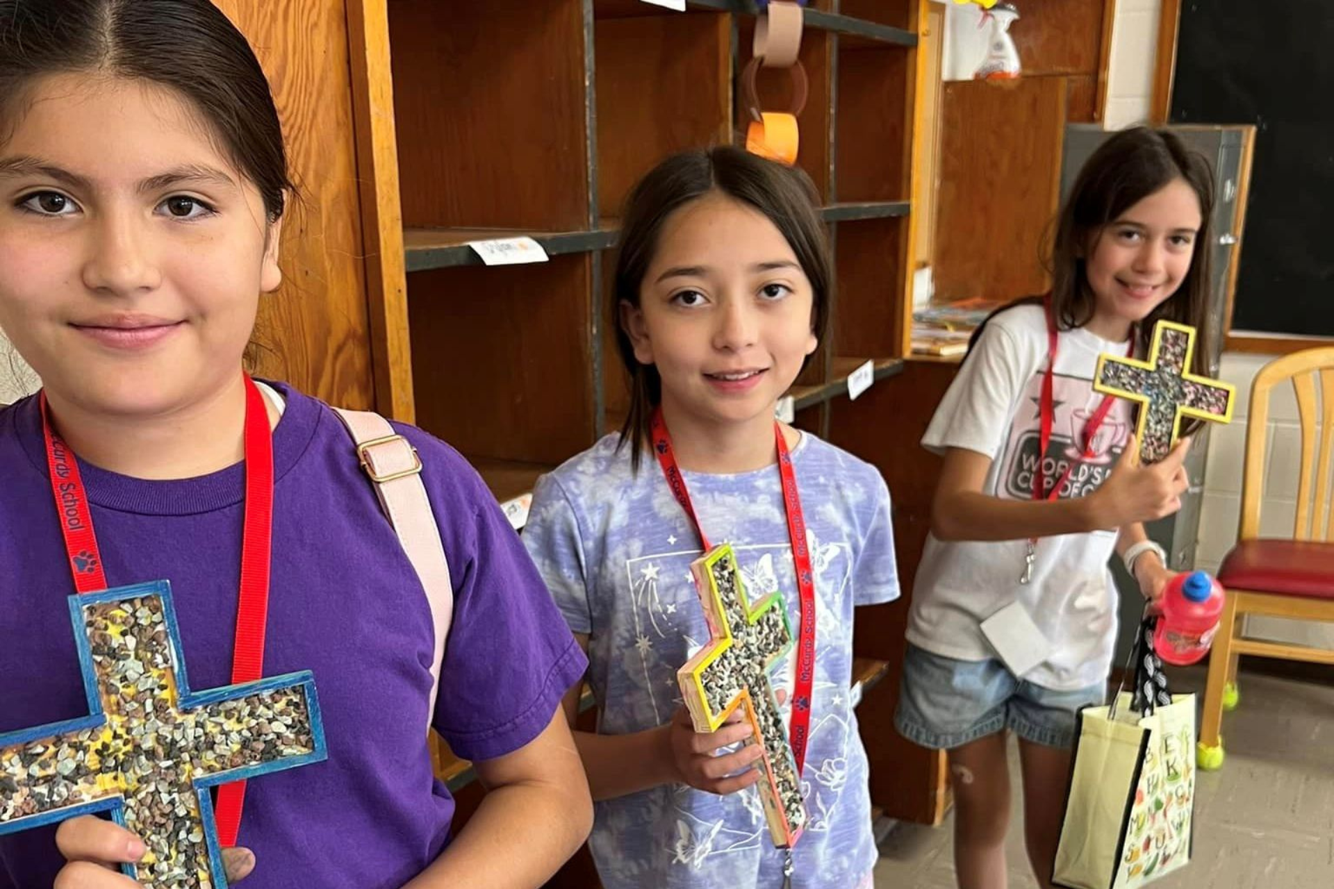 Three children holding crosses