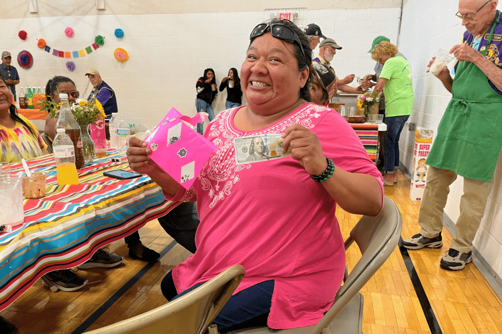 Woman holding a prize from a raffle she won