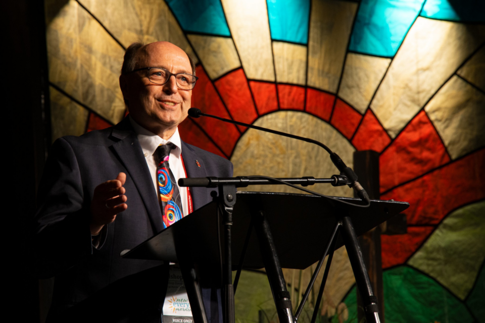 Bishop speaking at podium