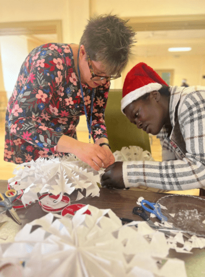 Two women decorating for Christmas