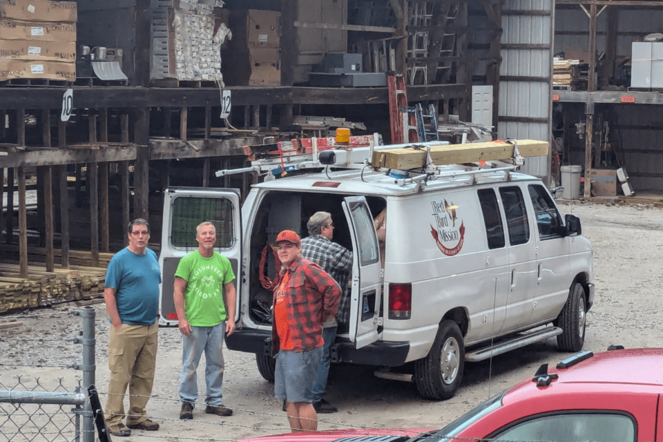 Men standing around a cargo van