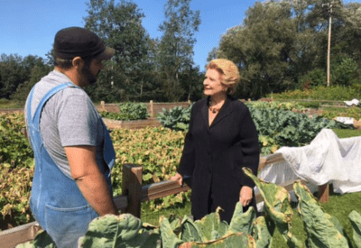 Senator speaking with farmer