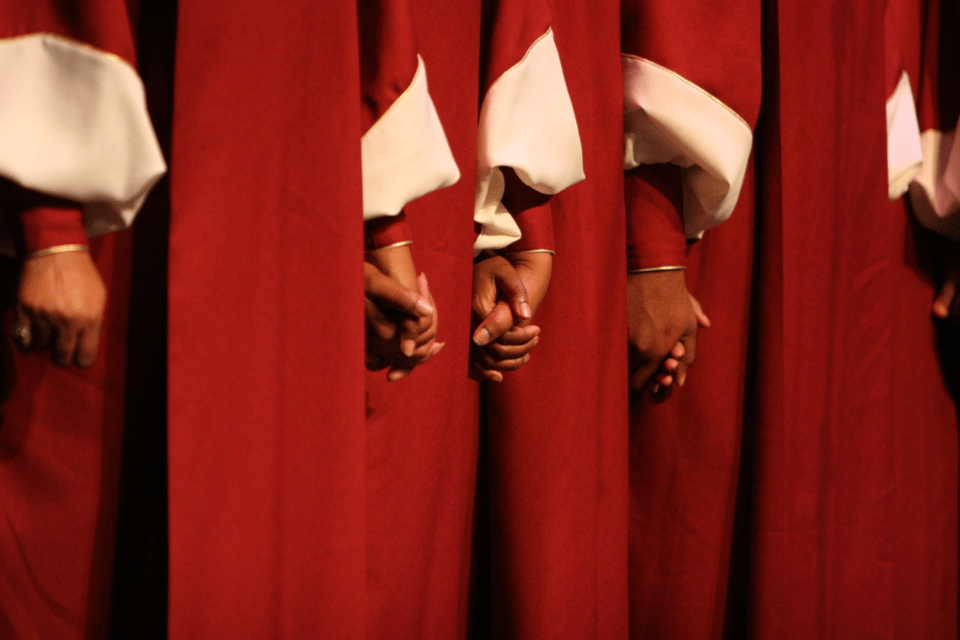 Members of a choir holding hands