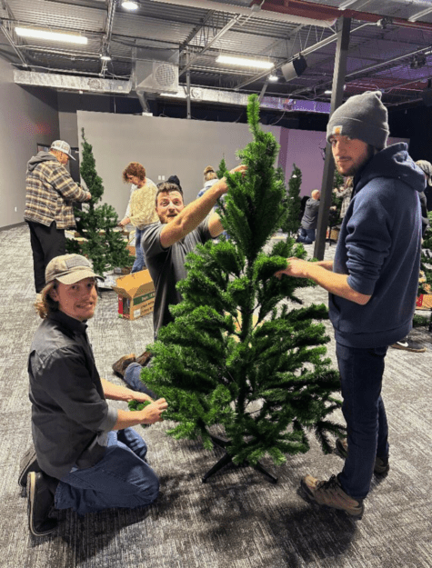 Young adults assembling an artificial Christmas tree