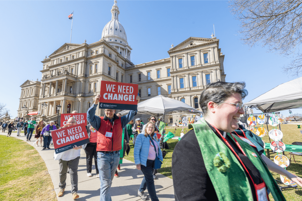 Group of people marching at the Michigan State Capitol