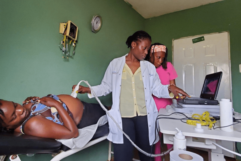 A doctor examines a woman at a clinic in Haiti