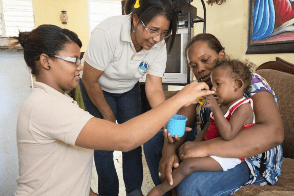 A child and mother beign cared for by medical professionals in Haiti