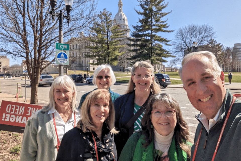 People standing in front of the Michigan State Capitol