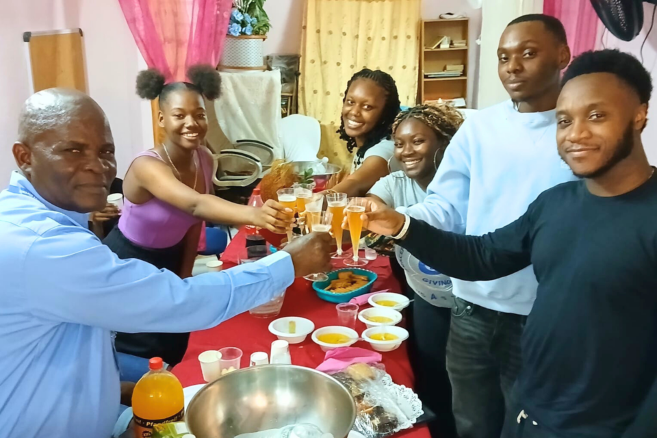 Youth and a pastor having refreshments