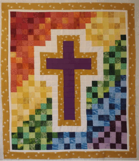 Cross on a rainbow quilt