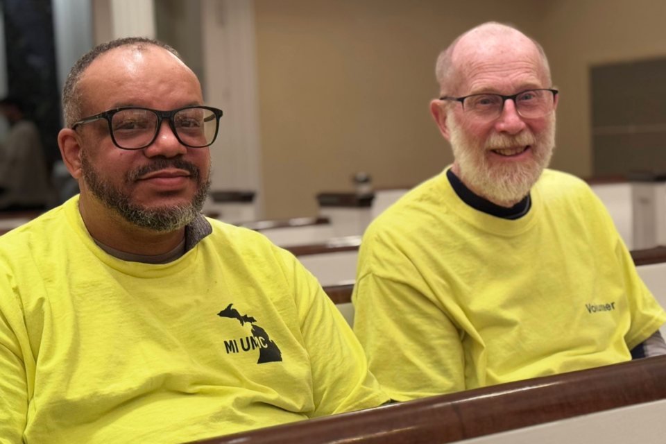 Two men sitting in a church pew