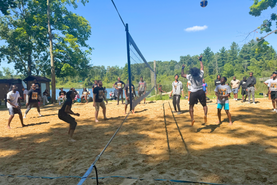 Young adults playing volleyball