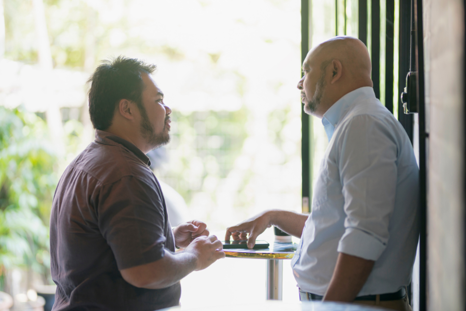 Two men speaking to each other